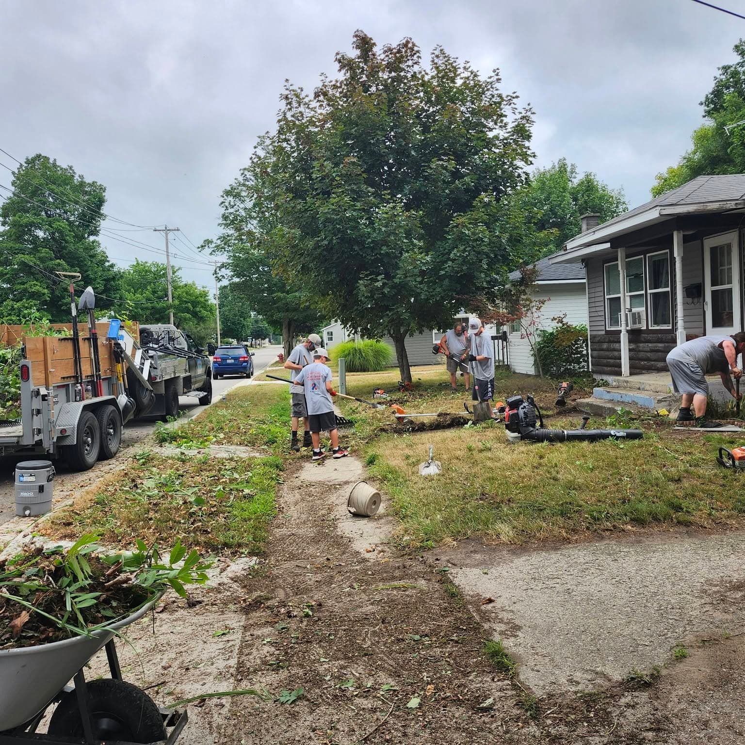 Fresh Cuts crew on a property cleanup with trailer and tools
