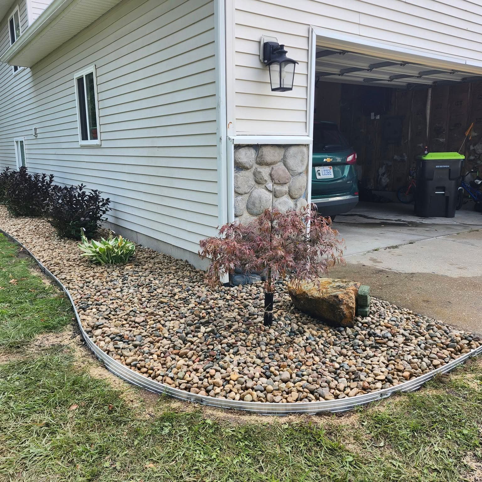 Japanese maple and shrub plantings with river rock by Fresh Cuts
